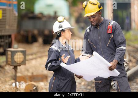 Railway technicians and engineers, Working on the train tracks at train station Stock Photo