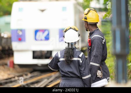 Railway technicians and engineers, Working on the train tracks at train station Stock Photo