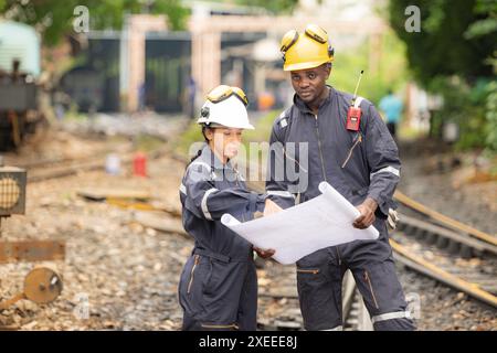 Railway technicians and engineers, Working on the train tracks at train station Stock Photo