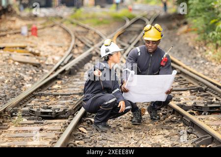 Railway technicians and engineers, Working on the train tracks at train station Stock Photo