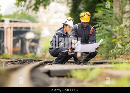 Railway technicians and engineers, Working on the train tracks at train station Stock Photo
