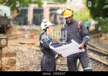 Railway technicians and engineers, Working on the train tracks at train station Stock Photo