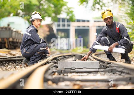Railway technicians and engineers, Working on the train tracks at train station Stock Photo