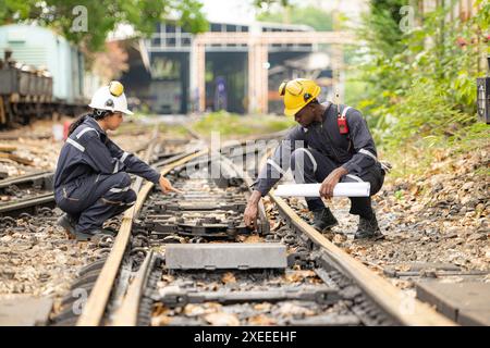 Railway technicians and engineers, Working on the train tracks at train station Stock Photo