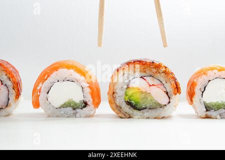 Soft Shell assorted sushi covered by salmon and unagi or eel, round sushi rolls. Philadelphia rolls filled with salmon, cream cheese, avocado Stock Photo