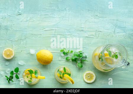 Lemonade with mint. Lemon water drink with ice. Two glasses and a pitcher Stock Photo