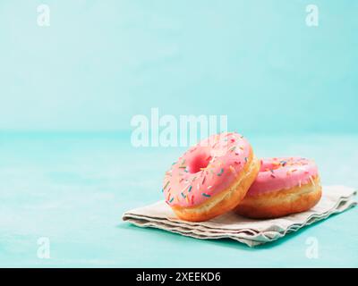 Pink donuts on blue background , copy space Stock Photo