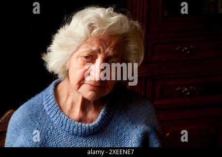 Portrait of old woman at home, looking at the camera. Close view. Stock Photo