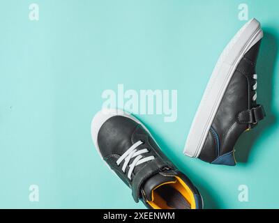 Gray and yellow sneakers on blue background Stock Photo