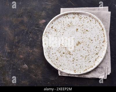 White craft plate on black slate table Stock Photo