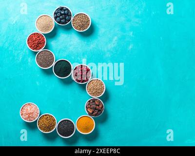 S letter of superfoods in bowl on blue background Stock Photo