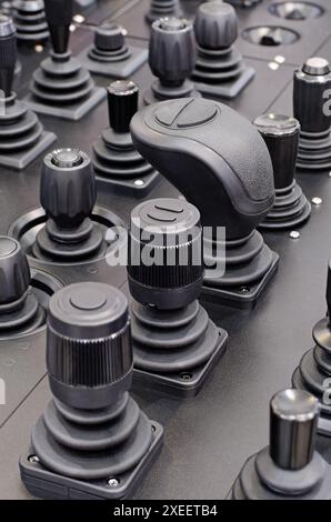 Big group of various control sticks on a black dashboard Stock Photo