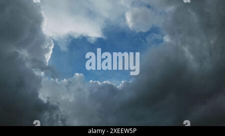 Storm clouds and hole with blue sky Stock Photo