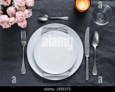 Beautiful table setting on gray linen tablecloth Stock Photo