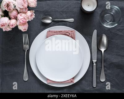 Beautiful table setting on gray linen tablecloth Stock Photo