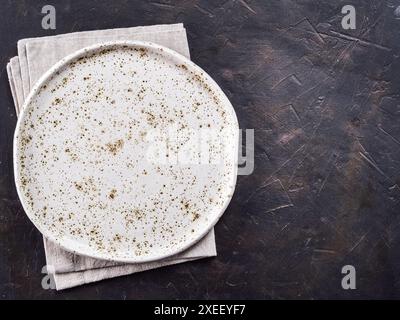 White craft plate on black slate table Stock Photo