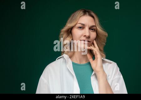 Woman in Green Shirt Posing for Picture Stock Photo