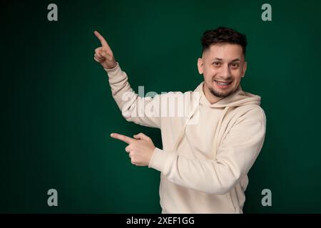 Man in White Hoodie Pointing at Something Stock Photo