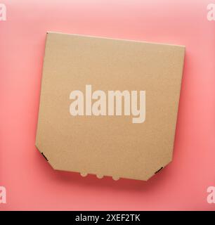 Pizza closed carton box on uniform pink background flat lay mockup with copyspace Stock Photo
