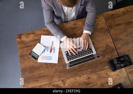 Office man working in finance with charts and laptop Stock Photo