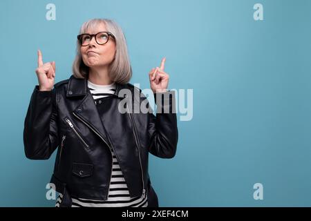 Middle age business. 60s mature woman in gray hair looking great in stylish look on bright background Stock Photo