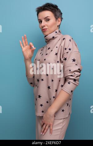 Young successful confident caucasian woman with short gray hair is dressed in a suit of skirt and blouse Stock Photo