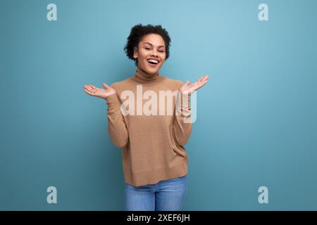 Young attractive latin woman with black afro hair pulled back in ponytail isolated on background with copy space Stock Photo
