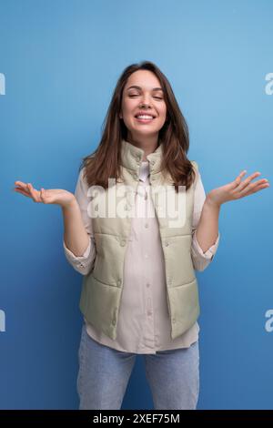Positive cheerful black-haired young lady in casual clothes over isolated background Stock Photo