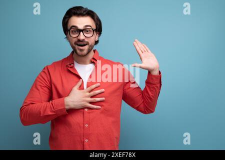 Smart handsome young brunette man with glasses explains an idea Stock Photo