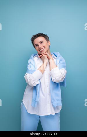 Dreamy brunette short haired young woman in casual look Stock Photo