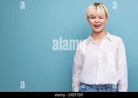 Young pretty caucasian blond career woman in white blouse isolated on blue background with copy space Stock Photo