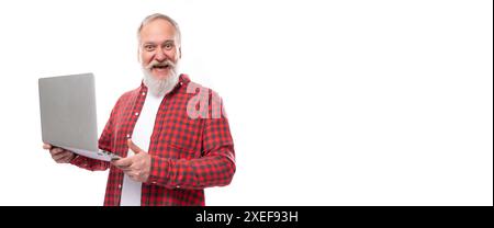 Smart 60s middle aged mature man in a stylish shirt masters a laptop Stock Photo