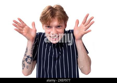 A handsome young blond man in a blue polo tells a funny story Stock Photo