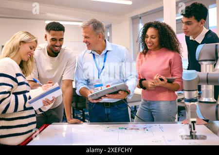 Group Of College Or University Engineering Students In Robotics Class With Male Teacher Stock Photo
