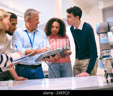 Group Of College Or University Engineering Students In Robotics Class With Male Teacher Stock Photo