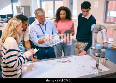 Group Of College Or University Engineering Students In Robotics Class With Male Teacher Stock Photo