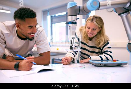 Male And Female College Or University Engineering Students In Robotics Class Working Together Stock Photo