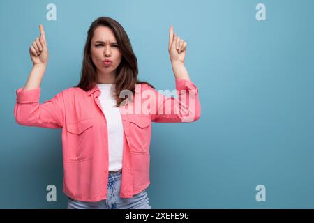 Active emotional black-haired lady in casual style on studio background Stock Photo