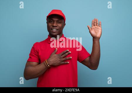 Corporate color. american man wearing red t-shirt and cap on background with copy space Stock Photo