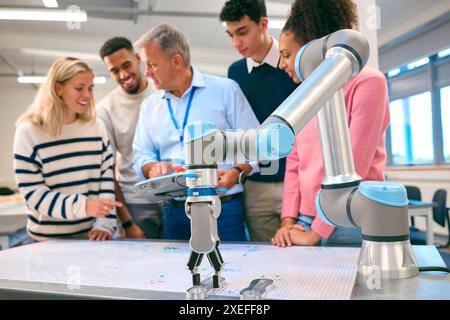 Group Of College Or University Engineering Students In Robotics Class With Male Teacher Stock Photo