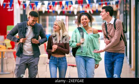 Group Of University Students With Bags Socialising In College Building Stock Photo