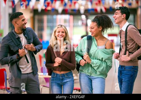 Group Of University Students With Bags Socialising In College Building Stock Photo