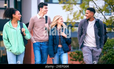 Group Of University Students Outdoors Walking Past College Buildings Stock Photo
