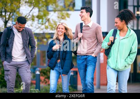 Group Of University Students Outdoors Walking Past College Buildings Stock Photo
