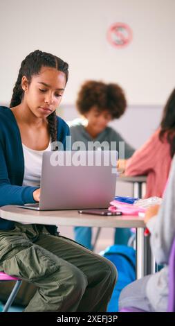 Female Secondary Or High School Pupil With Laptop Working In Study Area Stock Photo