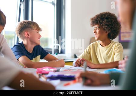 Two Male Secondary Or High School Students Sitting At Table In Science Class Working Together Stock Photo
