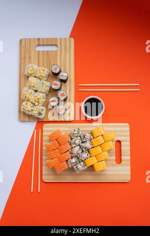 Sushi delivery. Set of rolls in a disposable box on a black background. Top view Stock Photo