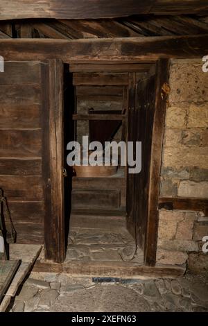 Old watermill interior with its wooden equipment showing the traditional way of grinding wheat Stock Photo