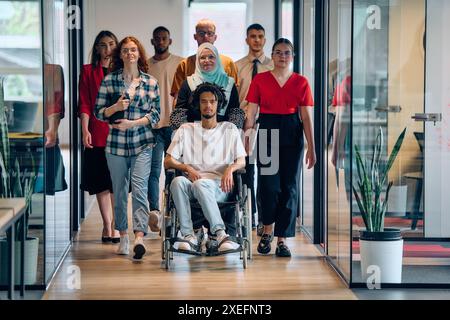 A diverse group of young business people congregates within a modern startup's glass-enclosed office, featuring inclusivity with Stock Photo