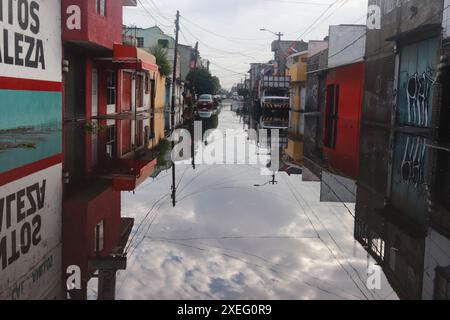 Mexico City, Mexico. 27th June, 2024. A driver crosses a flooded street ...